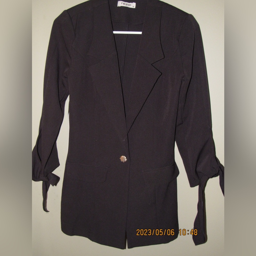 black suit, curvy design with design on the sides and knots for sleeves
